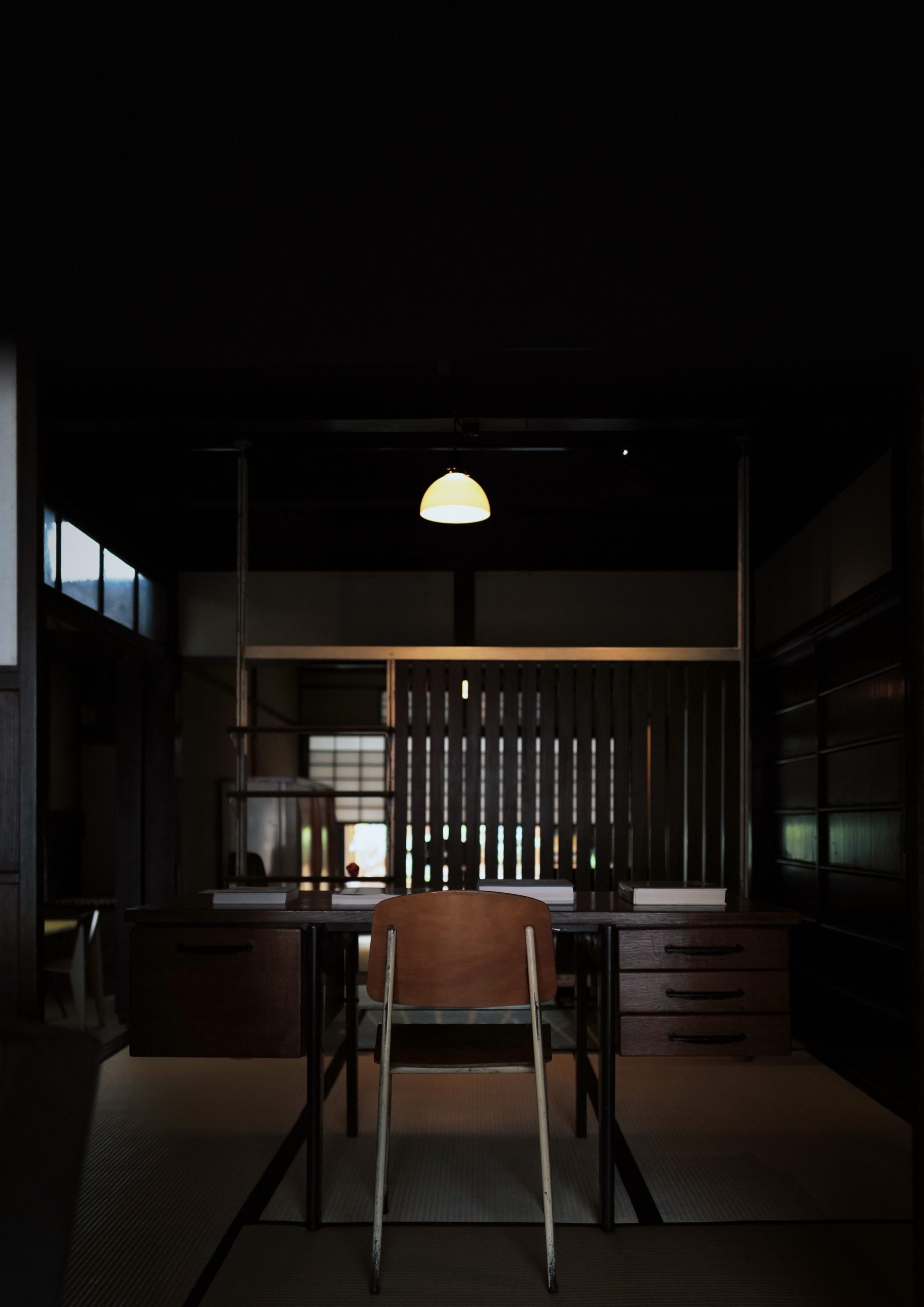 A Kyoto machiya interior: a desk and chair under a pendant lamp
